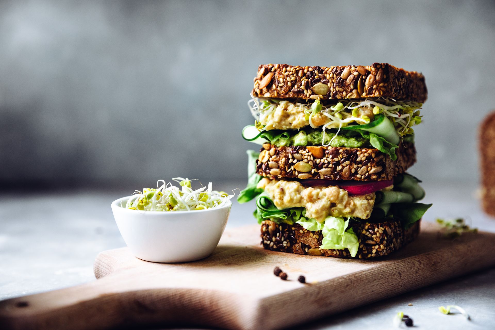 Vegan super sandwich served with sprouts