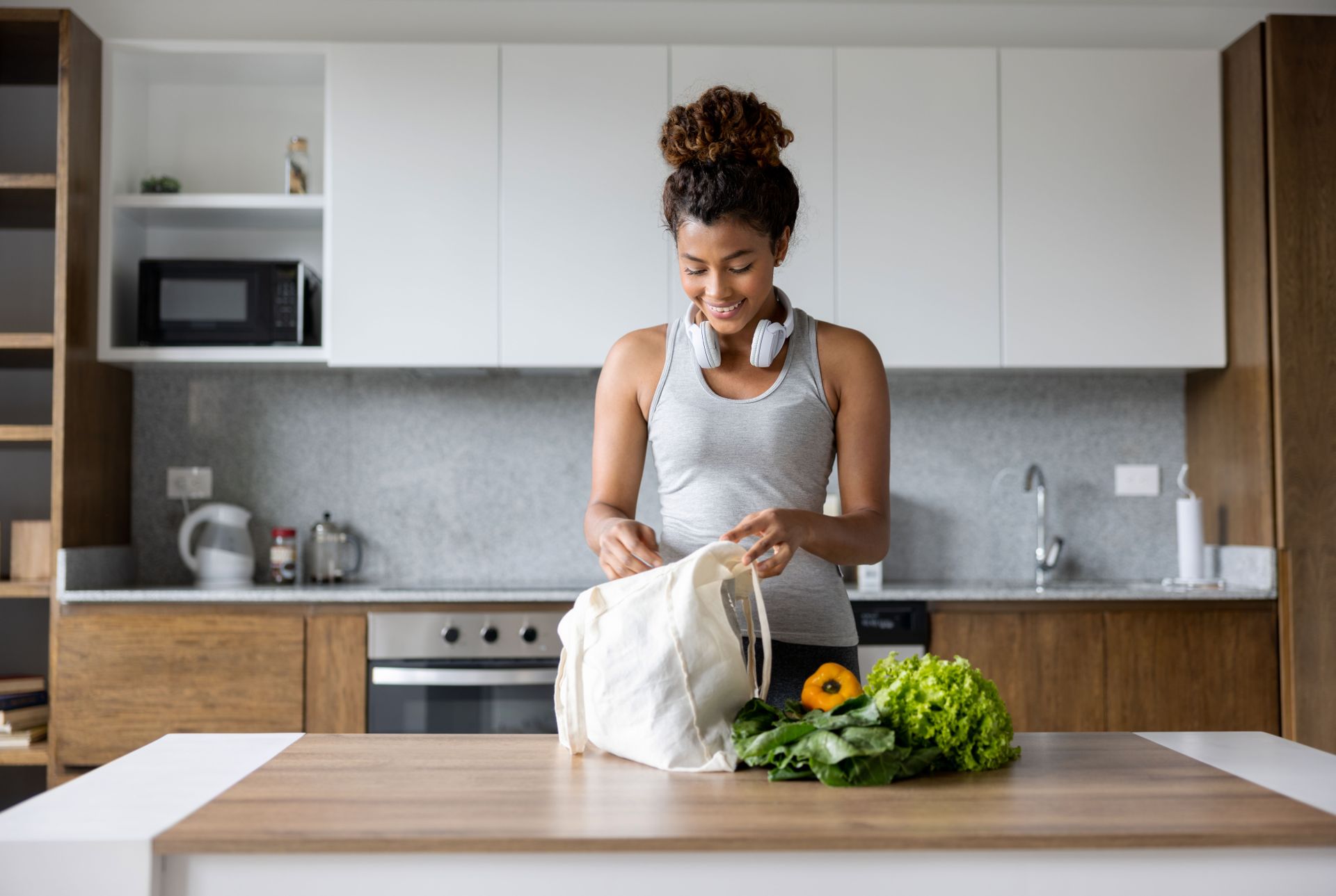 Woman unloading groceries at home 