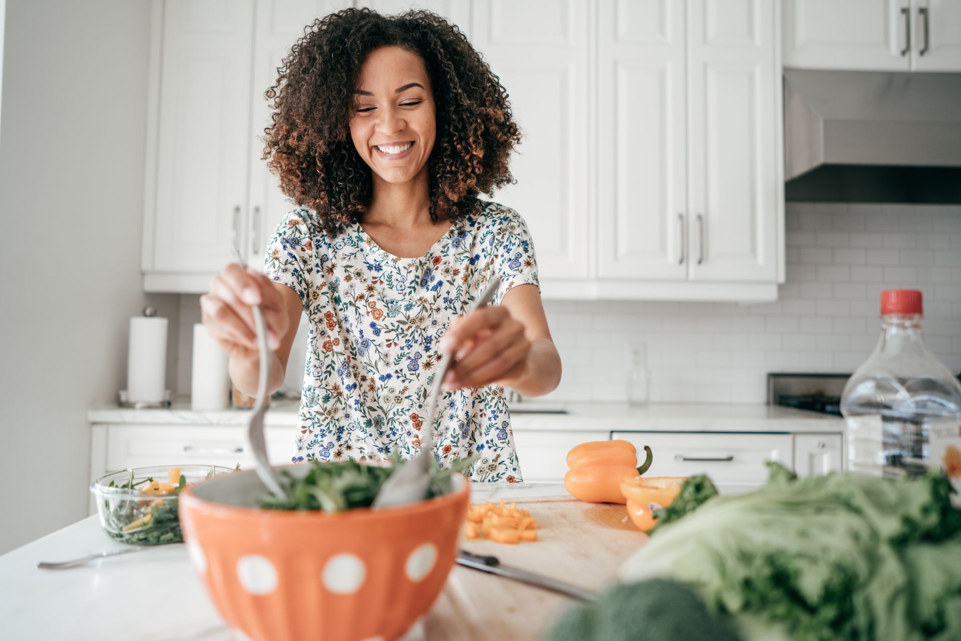 Woman mixing a salad in the kitchen