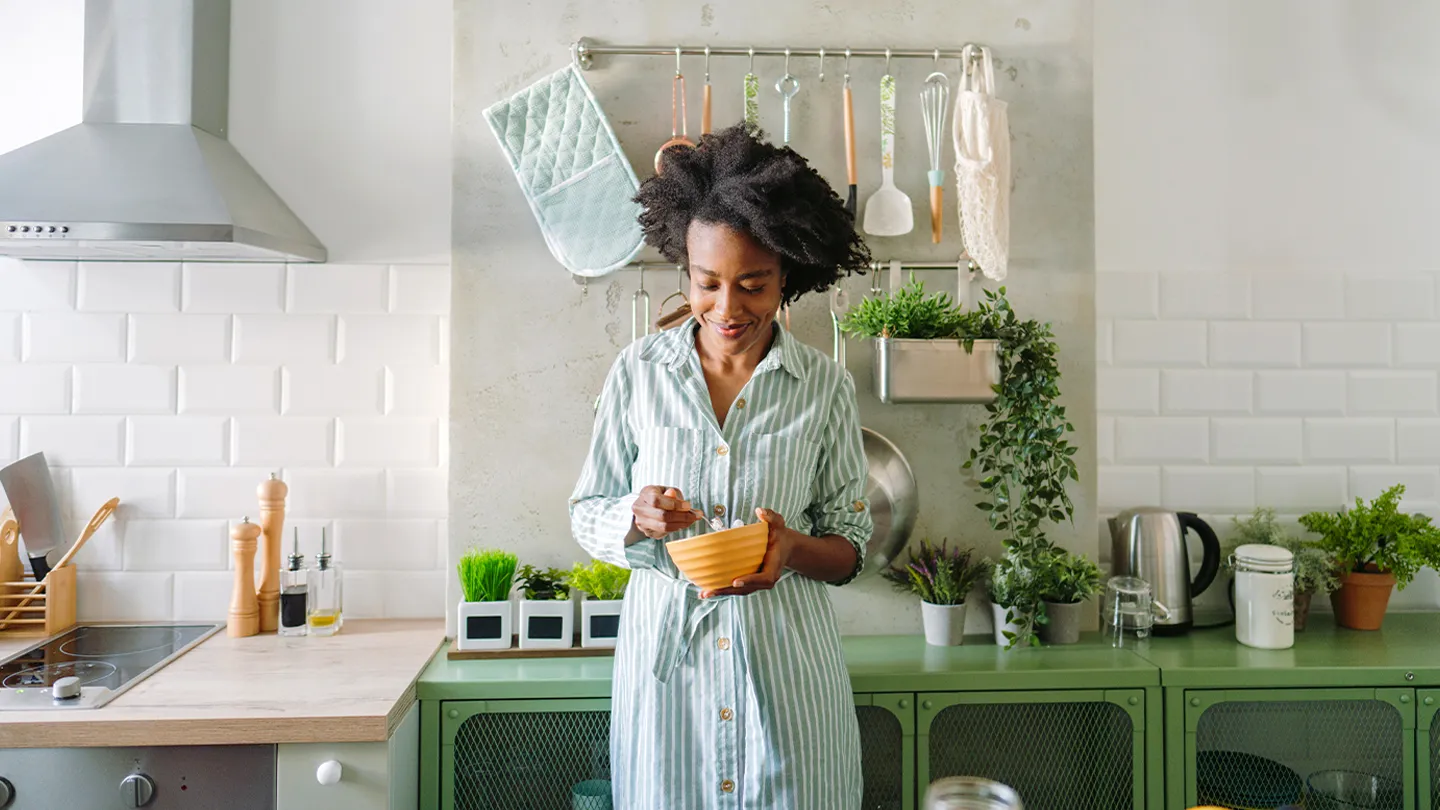 woman eating salad in kitchen